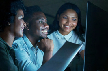 Three people looking at options on a screen