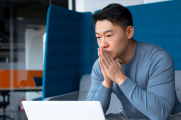 Man with hands on chin pondering a decision